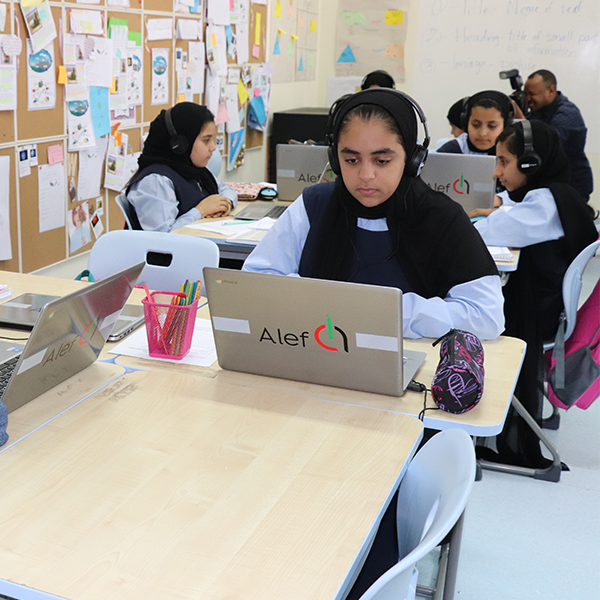 image of a boy studying online using laptop